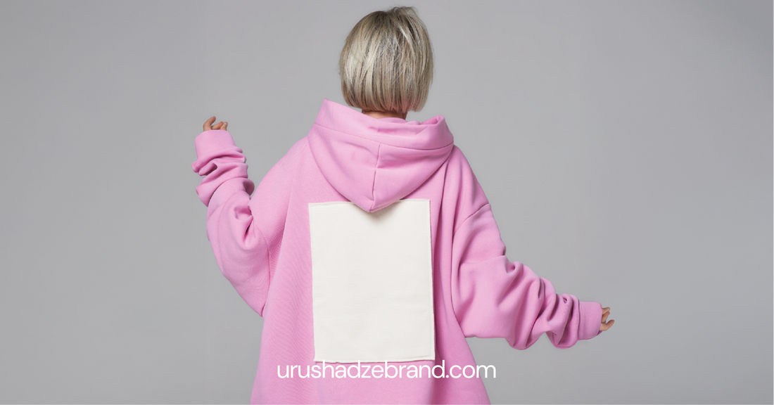 Woman wearing oversized pink hoodie — back view, relaxed fit unisex hoodie by URUSHADZE
