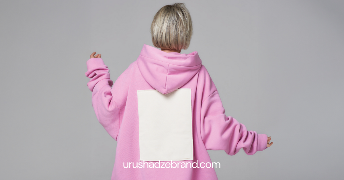Woman wearing oversized pink hoodie — back view, relaxed fit unisex hoodie by URUSHADZE