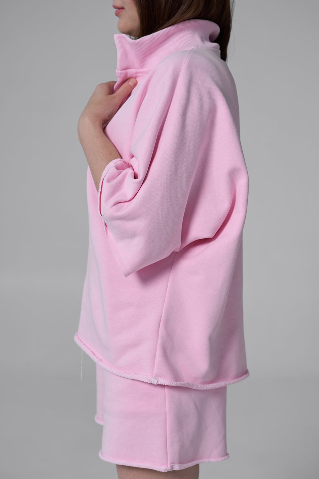 Pink outfit with a jacket and skirt on a gray background pink