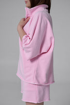 Pink outfit with a jacket and skirt on a gray background pink