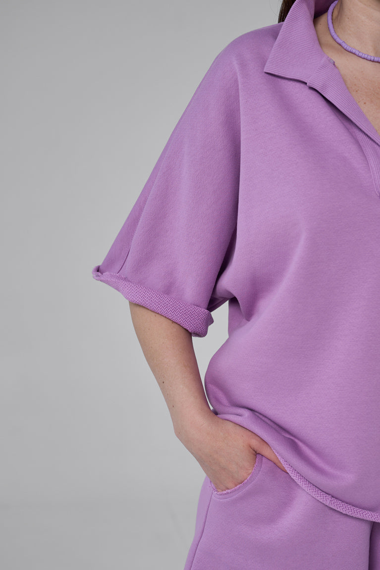 Purple outfit worn by a person on a gray background purple