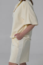 Light yellow dress with a skirt detail on a plain background yellow