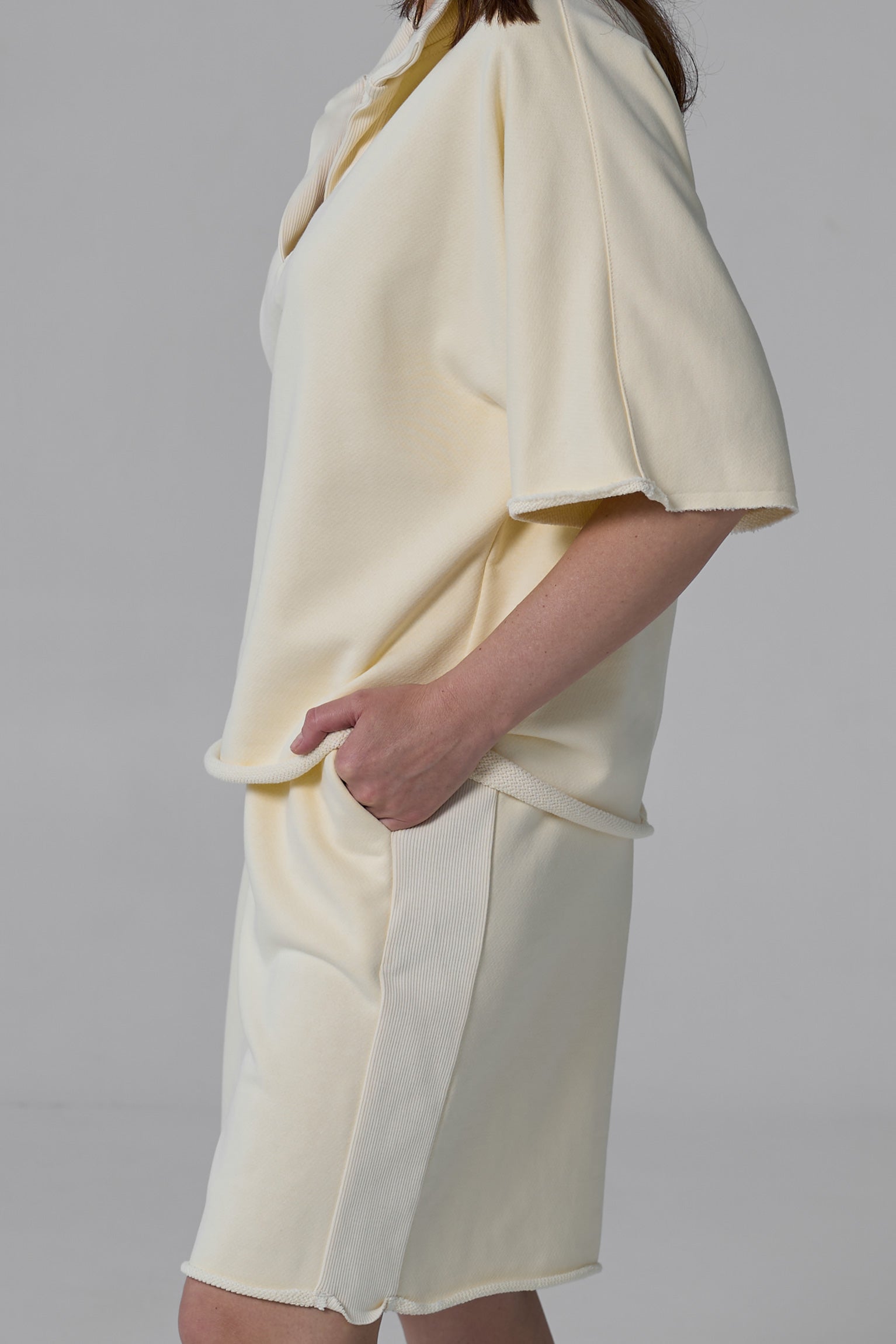 Light yellow dress with a skirt detail on a plain background yellow