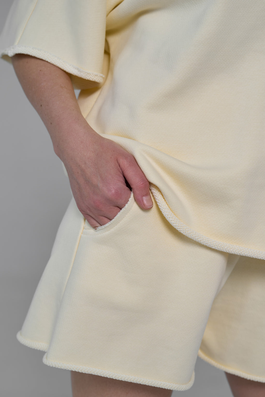 Light yellow dress with a skirt detail on a plain background yellow