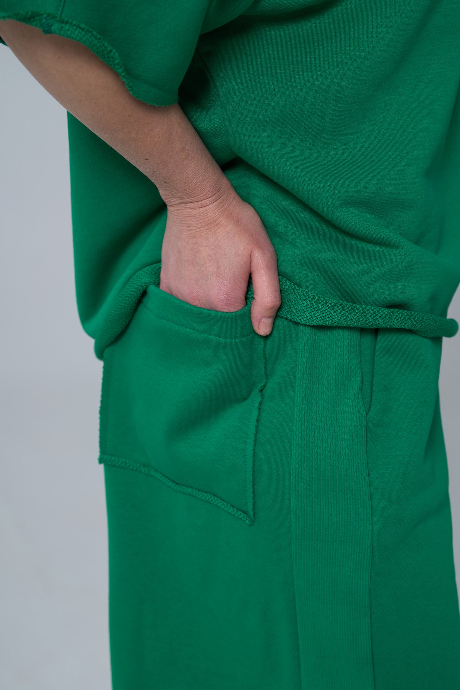 Green outfit with a pocket on a plain background emerald
